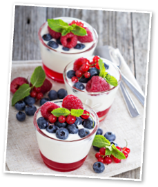 Jogurt and jelly dessert with berries in small glasses