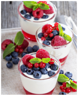 Jogurt and jelly dessert with berries in small glasses
